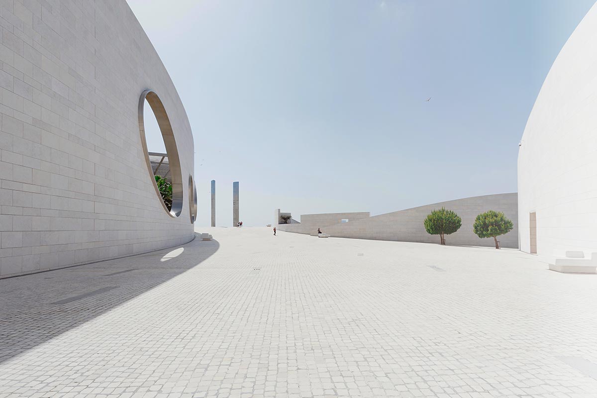 Modern architectural plaza with circular window.